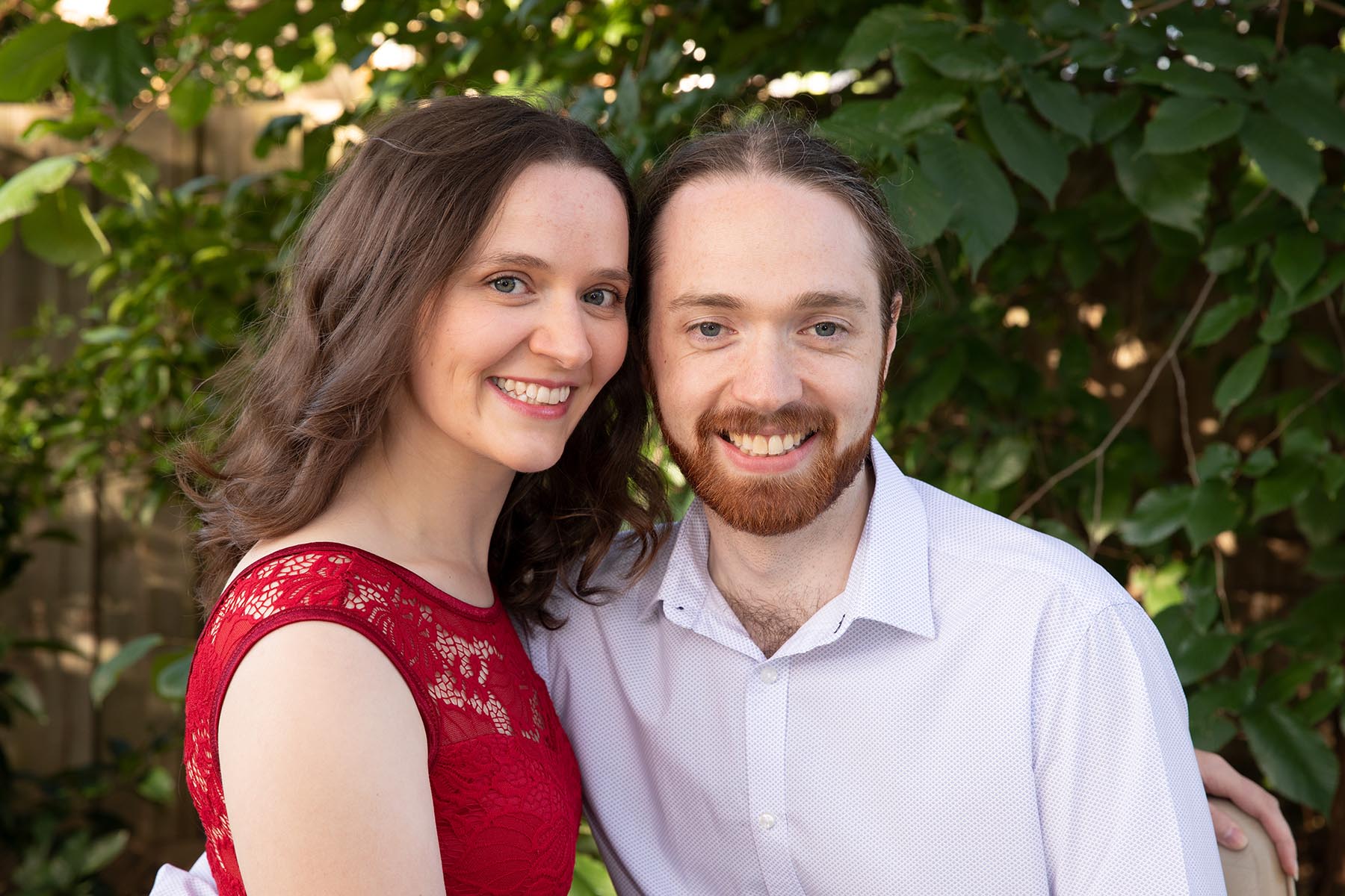 A photograph of Megan and Adam together with greenery in the background